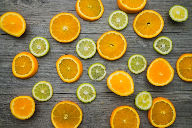 Top view of lemon and orange slices on wooden surface