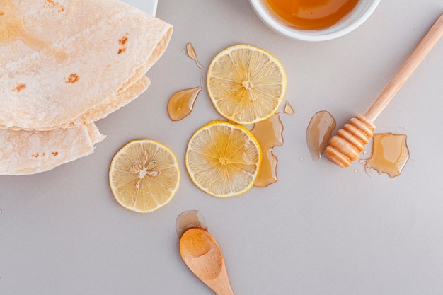 Top view lemon slices covered in honey