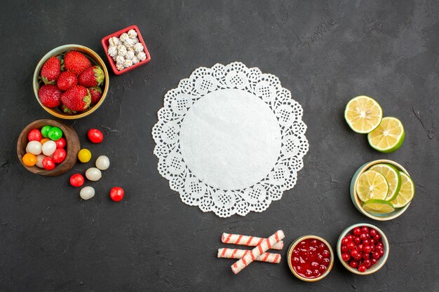 Top view lemon slices with candies and fruits