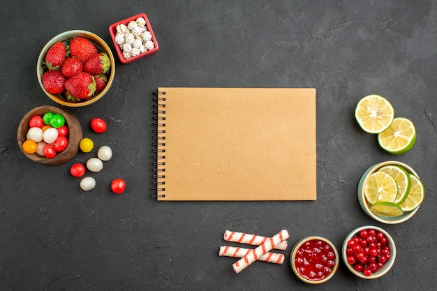 Top view lemon slices with candies and fruits