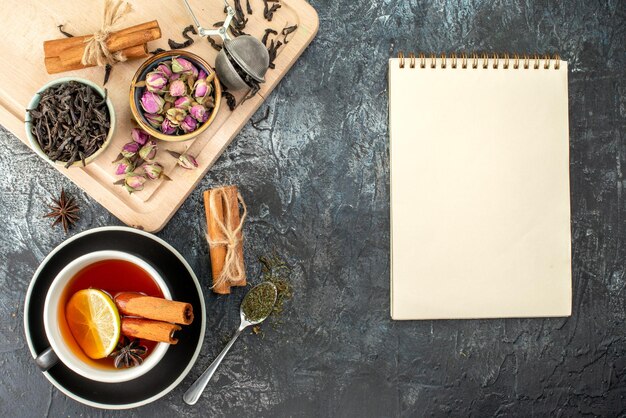 Top view lemon tea in cup and kettle on gray background color morning breakfast photo food ceremony