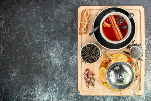 Top view lemon tea in cup and kettle on gray background fruit breakfast ceremony color food morning photo