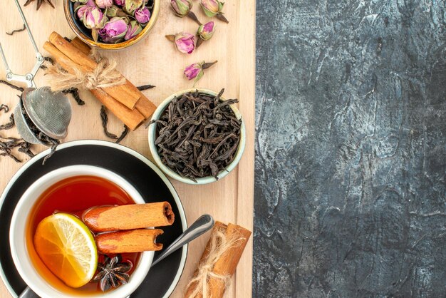 Top view lemon tea in cup and kettle on gray background morning fruit breakfast ceremony photo food