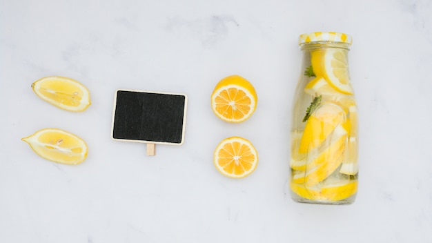 Top view lemonade with lemons and blackboard