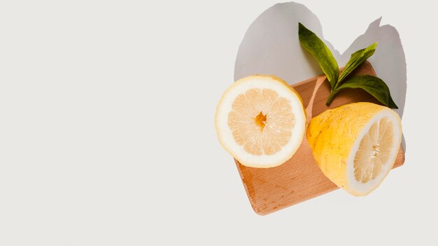 Top view lemons on wooden board