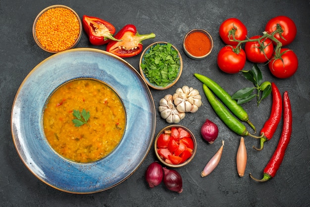 Top view of lentil soup lentil soup next to the colorful vegetables