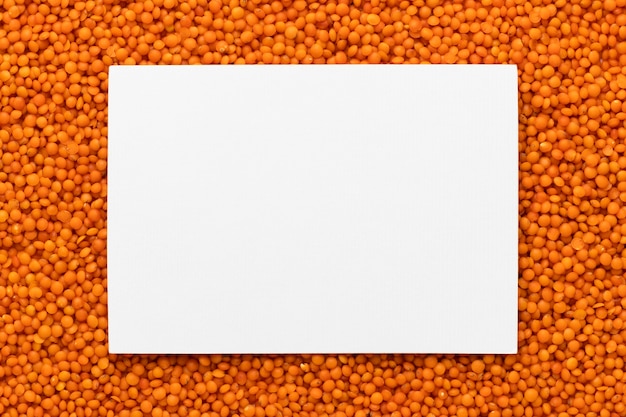 Free photo top view lentils frame with paper