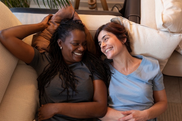 Top view lesbian couple laying on couch