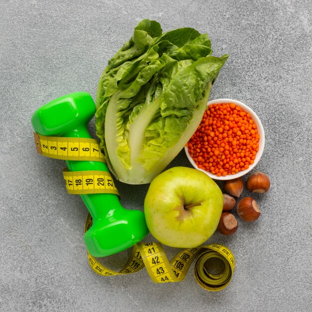 Top view of lettuce with apple and weight