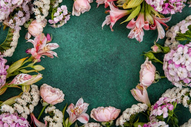 Top view of light pink flowers on a green surface