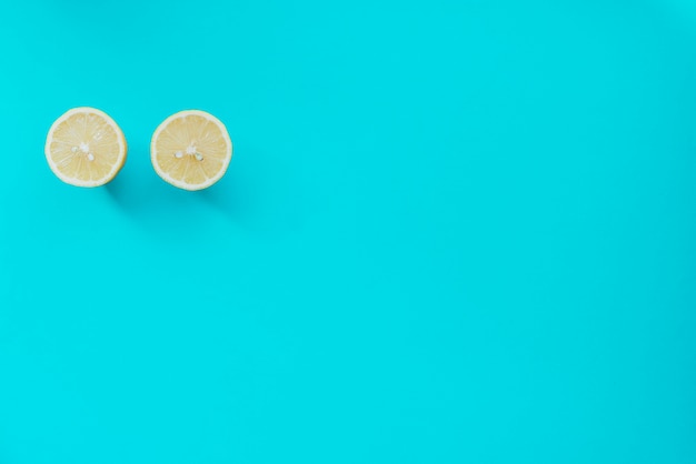 Top view of lime cut in half on blue surface