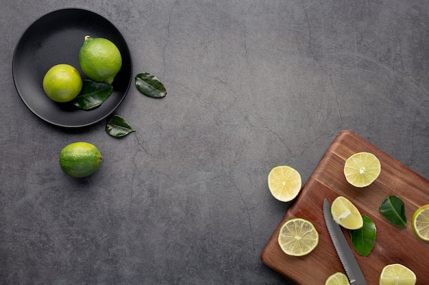 Top view of limes and lemons with leaves