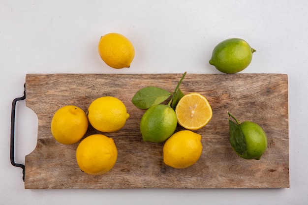 Top view limes with lemons on chalkboard on white background