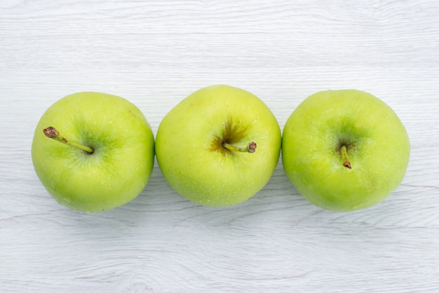 Top view lined green apples on the white background fruit mellow juice photo