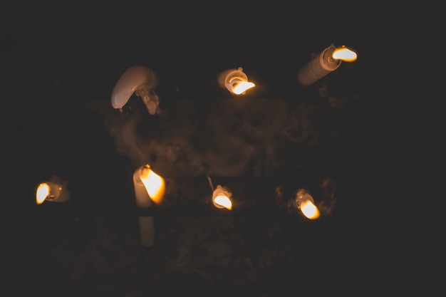 Top view of lit candles melting