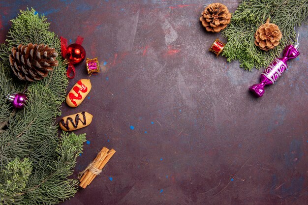 Top view of little biscuits with tree and cones on dark