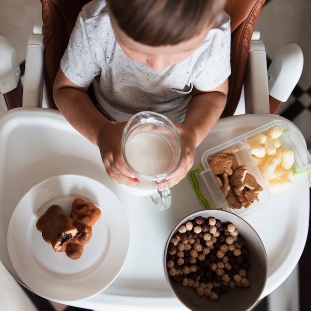 Top view little boy with assortment of snacks