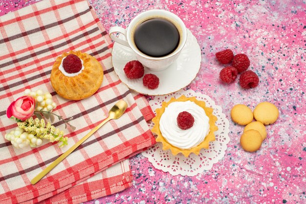 Вид сверху маленький торт со сливочным печеньем свежая малина вместе с чашкой кофе на цветной поверхности торт сладкое печенье цвет чая