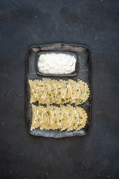 Top view little cooked dumplings with meat inside on dark surface