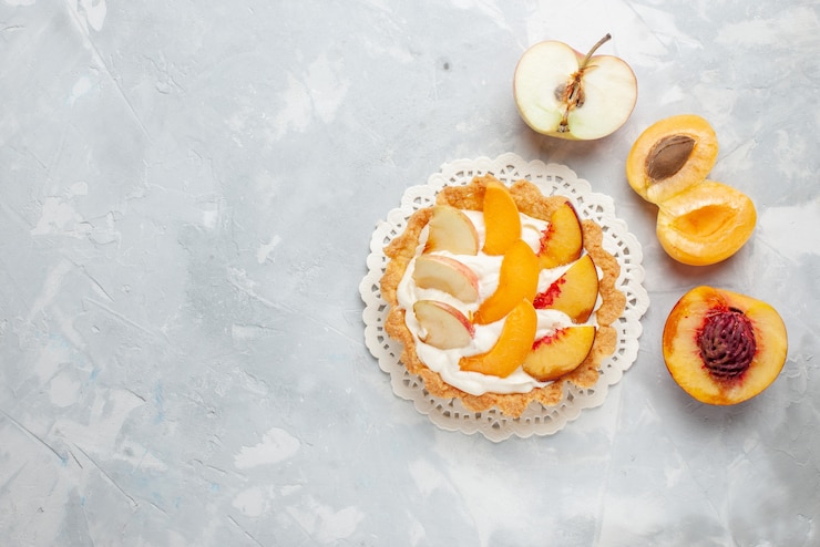 Free Photo top view little creamy cake with sliced fruits and white cream on the white-light floor fruit cake sweet biscuit cookie bake