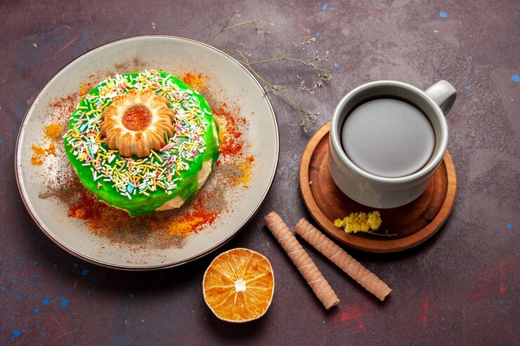 Free Photo top view little delicious cake with cookie and cup of tea on dark surface
