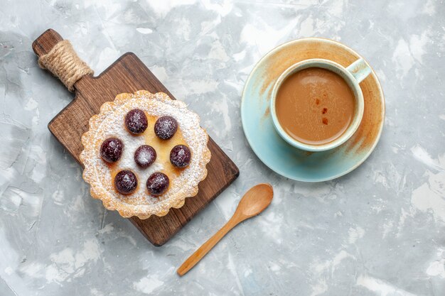 Top view little delicious cake with sugar powder and milk coffee on the light desk biscuit sweet bake sugar photo