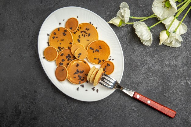 Top view little pancakes with choco chips on grey