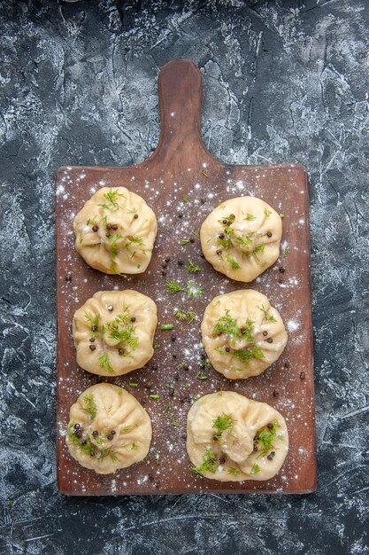 Top view little raw dumplings on light gray surface meat cuisine meal dough dish cake dinner