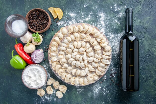 Top view little raw dumplings with flour on dark background meat dough food dish calorie meal color wine vegetable