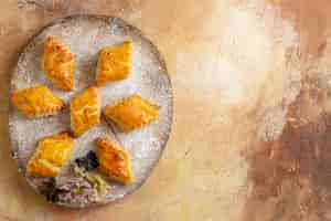 Free photo top view of little sweet pastries for tea on the light background