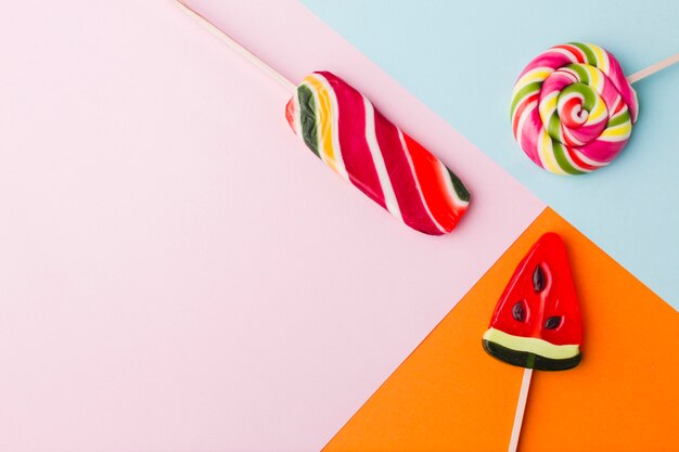 Top view lollipops on colorful table