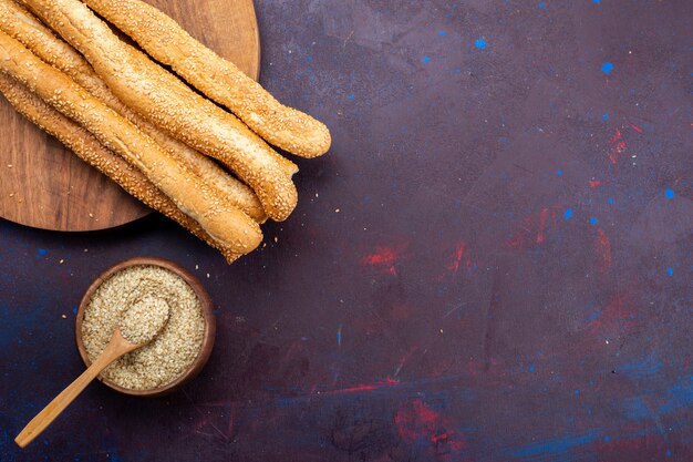 Top view of long bun bread long formed on dark surface