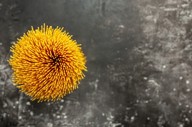 Top view long italian pasta raw on dark-grey background