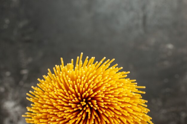 Top view long italian pasta raw on dark-grey background