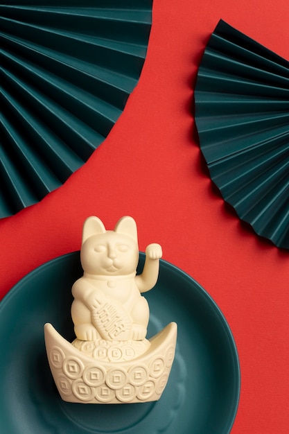 Top view lucky cat on blue plate