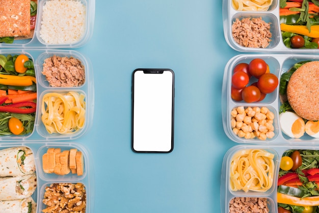 Free photo top view lunchboxes with blank phone