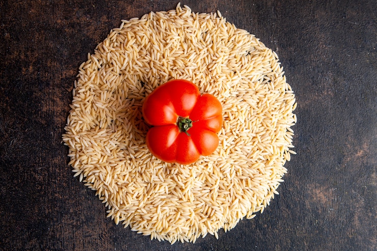 Free Photo top view macaroni in a circle form with tomato on them on dark textured background. horizontal