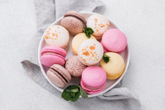 Top view of macarons in bowl with mint