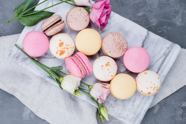 Top view of macarons on cloth with roses