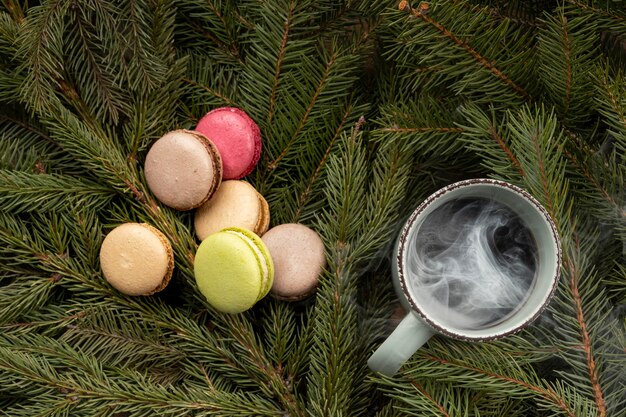 Top view macarons and hot drink on branches