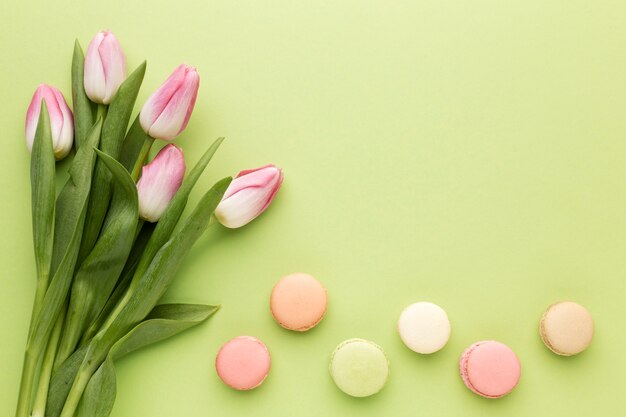 Top view macaroons beside tulips