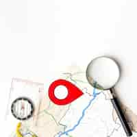 Free photo top view magnifying glass and map