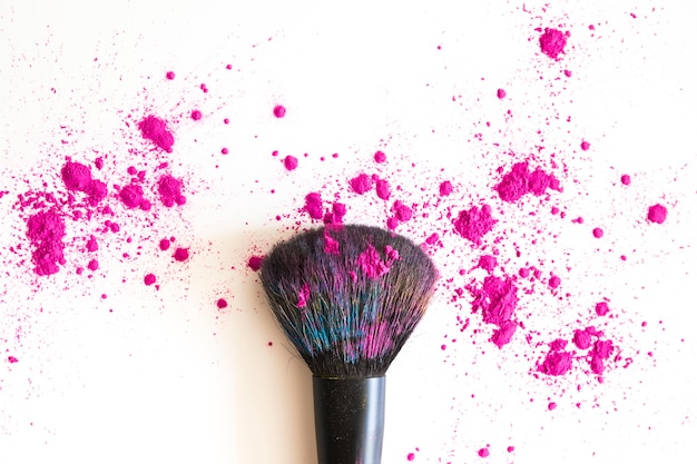 Free photo top view of make up brush and pink face powder