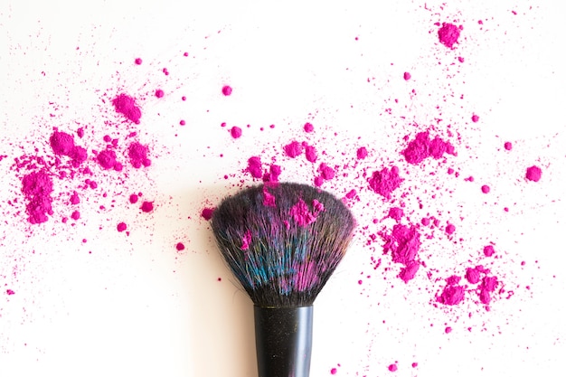 Top view of make up brush and pink face powder