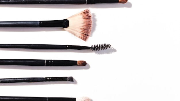 Top view make up brushes on white background