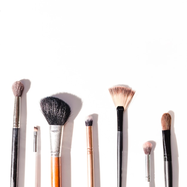 Free photo top view make up brushes on white background