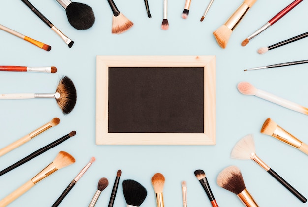 Top view make up brushes with blackboard