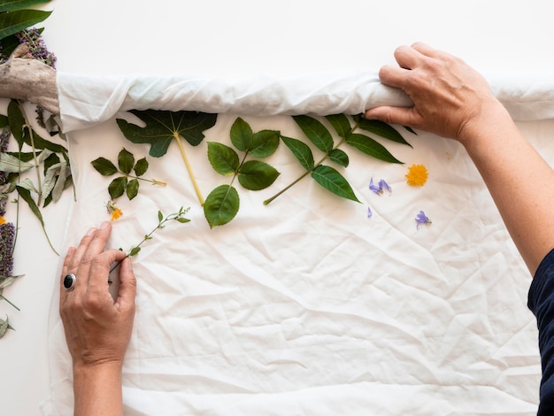 Free photo top view making of a pigmented cloth with natural colors composition