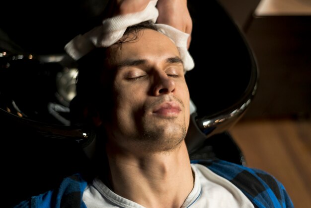 Top view man getting his hair washed 