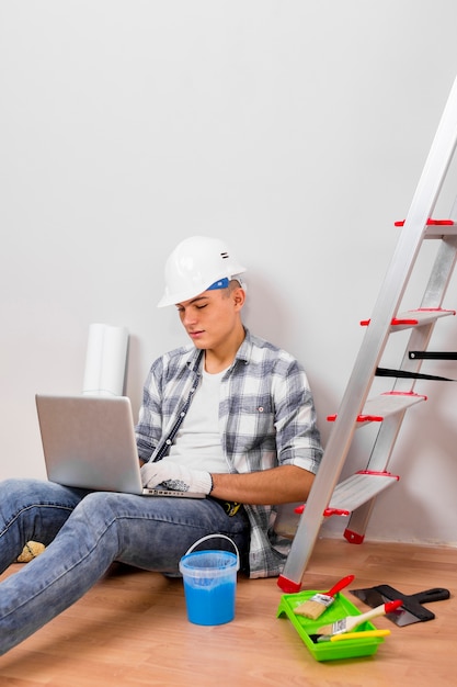 Free photo top view of man looking at his laptop